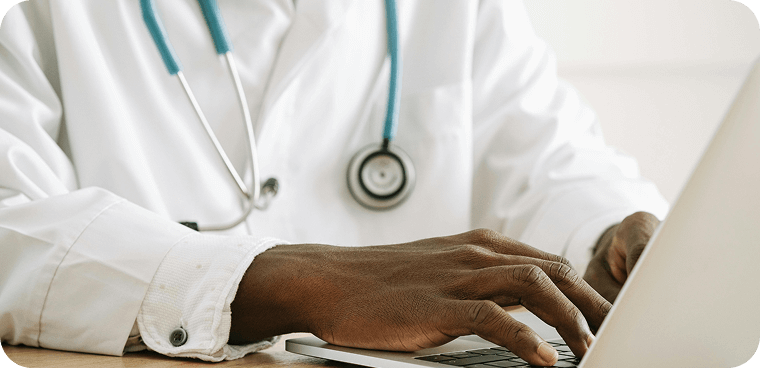 veterinarian typing on a laptop